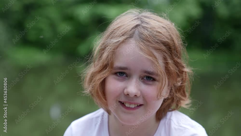 close-up portrait of a street urchin girl disheveled hair sleepy eyes smiling on the street close-up portrait of a street urchin girl disheveled hair sleepy eyes smiling on the street