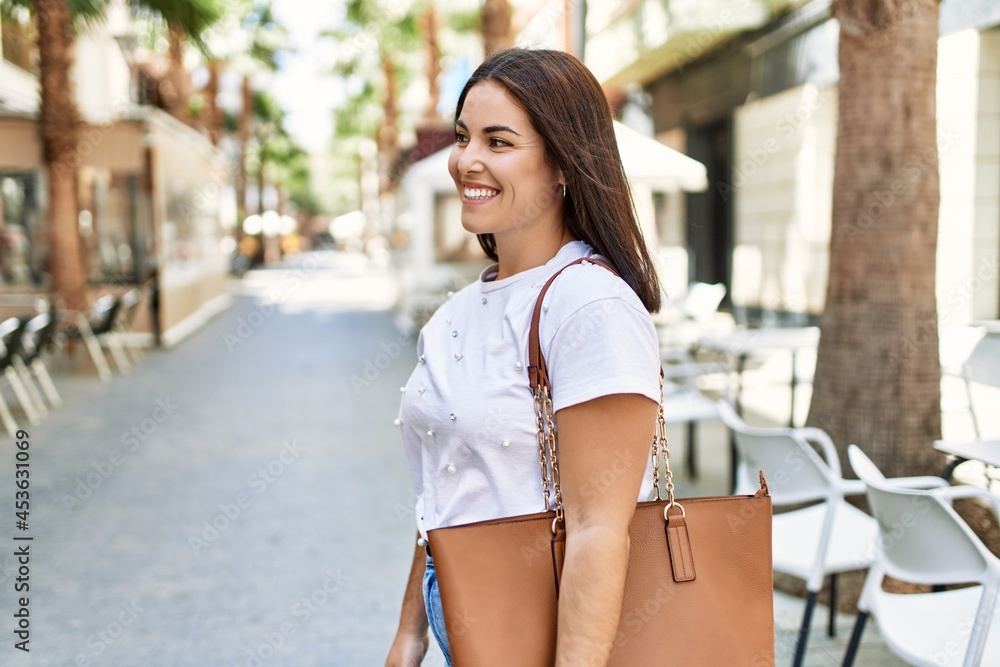 Young hispanic girl smiling happy standing at the city. Young hispanic girl smiling happy standing at the city.