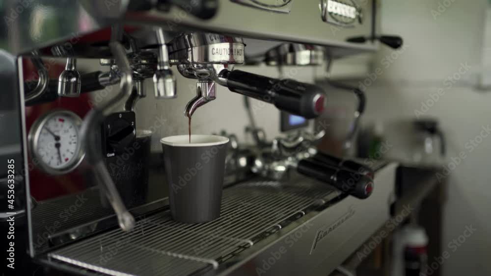 Coffee worker using a large coffee machine in a café. Coffee worker using a large coffee machine in a café.