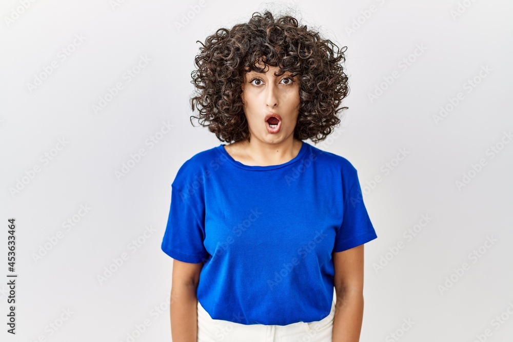 Young middle eastern woman standing over isolated background afraid and shocked with surprise expression, fear and excited face. Young middle eastern woman standing over isolated background afraid and shocked with surprise expression, fear and excited face.