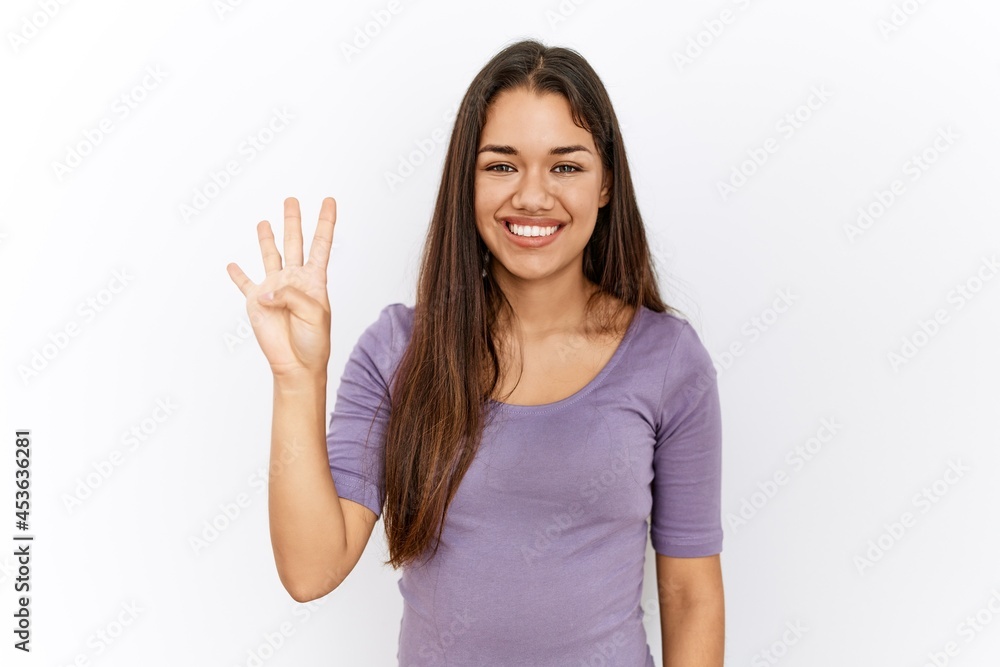 Young brunette woman standing by isolated background showing and pointing up with fingers number four while smiling confident and happy. Young brunette woman standing by isolated background showing and pointing up with fingers number four while smiling confident and happy.