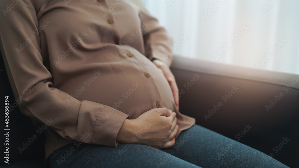 depressed pregnant woman touching her belly - obrazy, fototapety, plakaty 