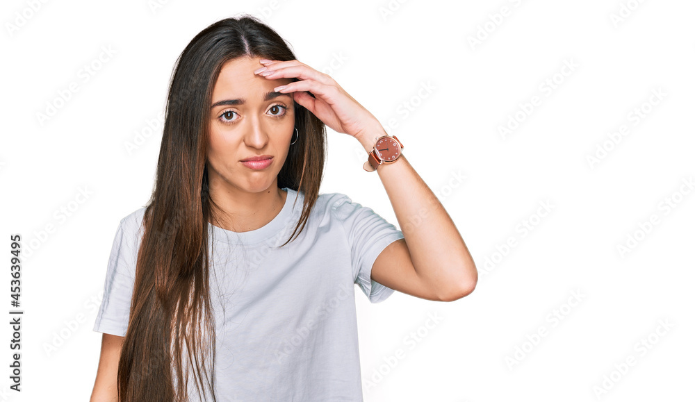 Young hispanic girl wearing casual white t shirt worried and stressed about a problem with hand on forehead, nervous and anxious for crisis Young hispanic girl wearing casual white t shirt worried and stressed about a problem with hand on forehead, nervous and anxious for crisis