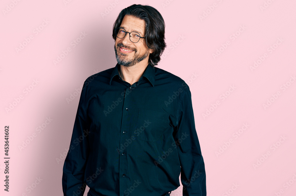Middle age caucasian man wearing casual clothes and glasses looking away to side with smile on face, natural expression. laughing confident. Middle age caucasian man wearing casual clothes and glasses looking away to side with smile on face, natural expression. laughing confident.