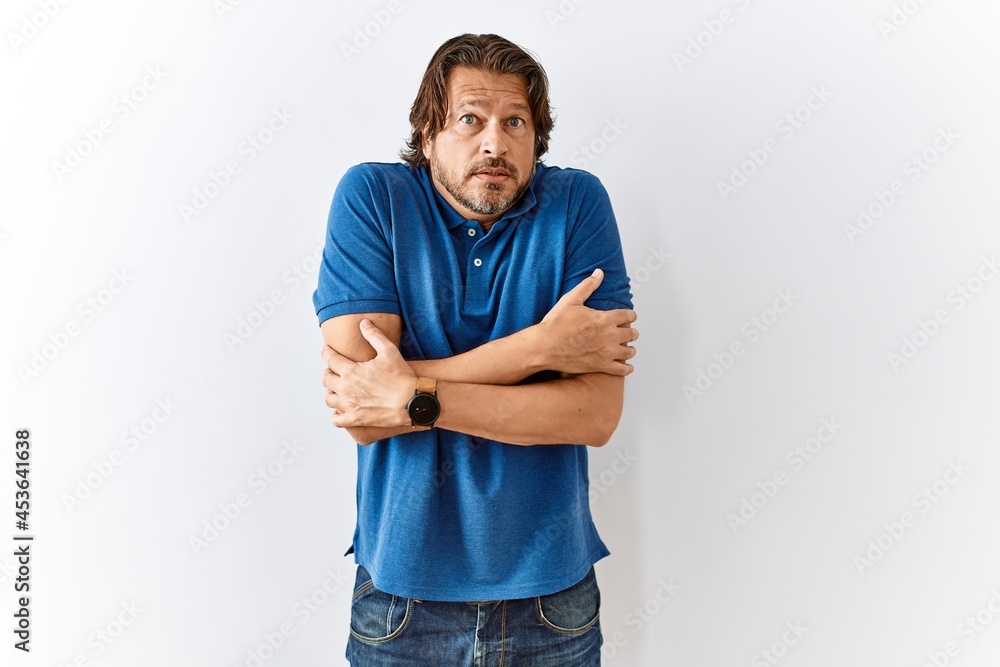 Handsome middle age man standing together over isolated background shaking and freezing for winter cold with sad and shock expression on face Handsome middle age man standing together over isolated background shaking and freezing for winter cold with sad and shock expression on face