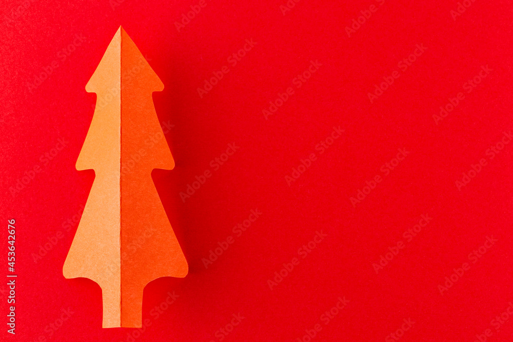 Red paper christmas tree. Paper Christmas tree on a red background. New Year decoration Red paper christmas tree. Paper Christmas tree on a red background. New Year decoration