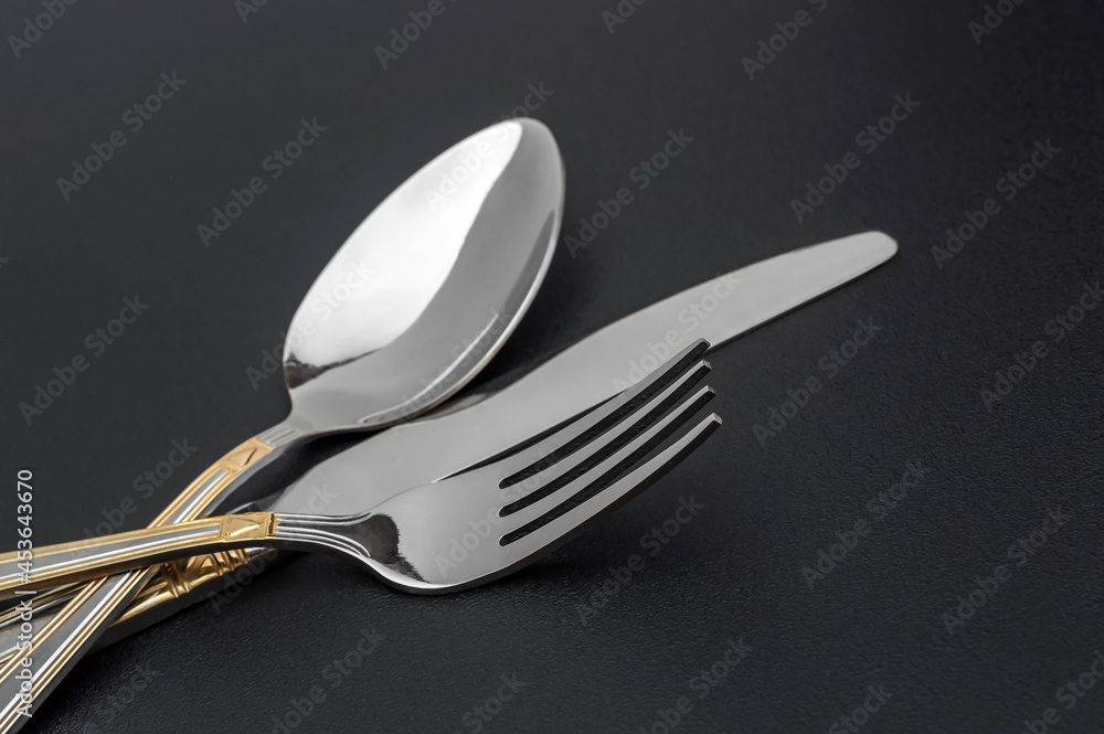 Fork, knife and spoon on black background. Fork, knife and spoon on black background.