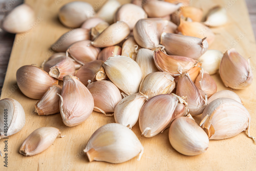 Garlic cloves on wooden chopping board. Garlic cloves on wooden chopping board.