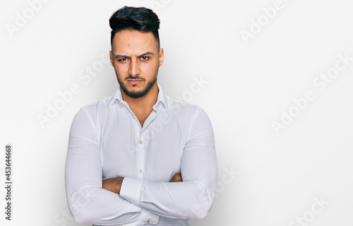 Young arab man wearing casual clothes skeptic and nervous, disapproving expression on face with crossed arms. negative person.