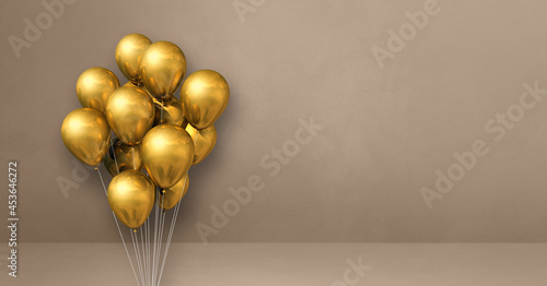 Gold balloons bunch on a beige wall background. Horizontal banner.