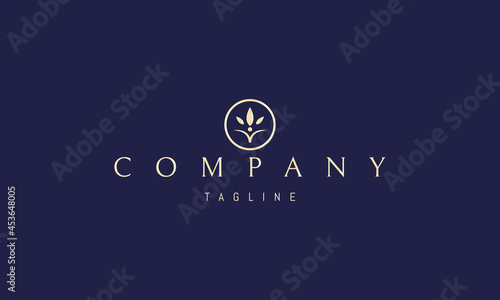Vector golden logo on which an abstract image of a flower with three leaves in a circle.