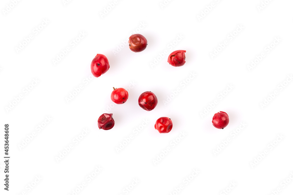 red peppercorns on white red peppercorns on white