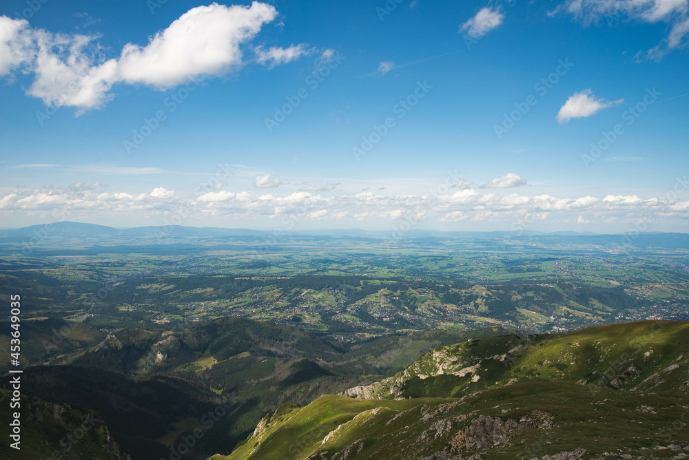 Top view on Zakopane from Tatra mountains trail with vivid cloudy sky
