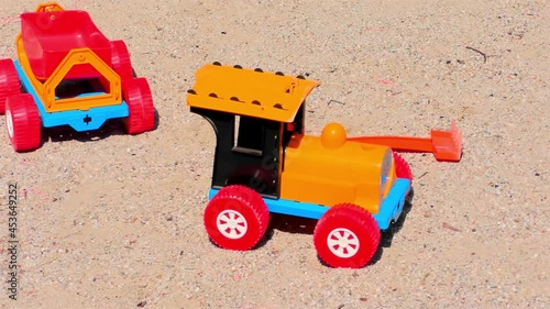 Old Toy Plastic Tractor in The Sand.