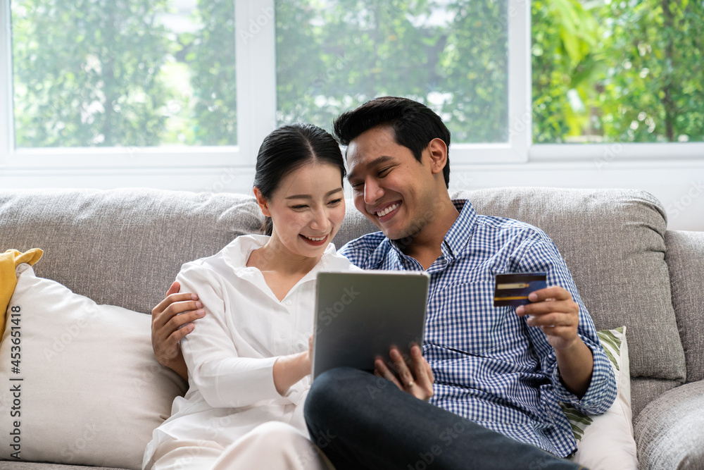 Happy Smiling Couple with Online Shopping Using Credit Card to Internet Shop on-line. Happy Smiling Couple with Online Shopping Using Credit Card to Internet Shop on-line.