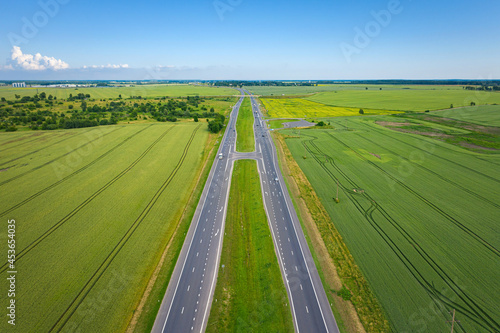 Asphalt highway through green summer field. Aerial view © photopixel