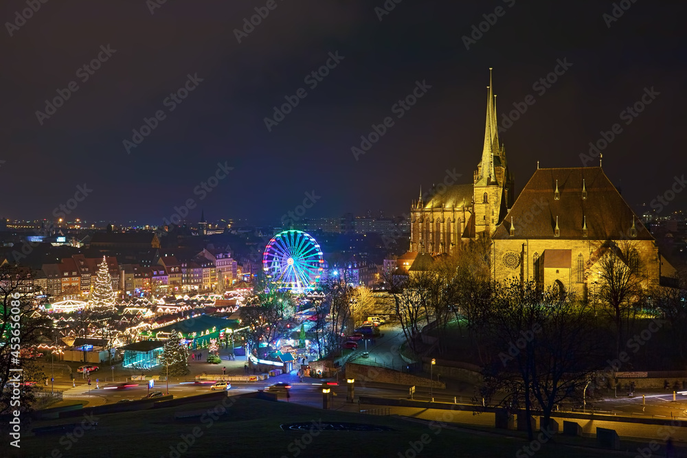 Erfurt, Germany. Christmas market on Domplatz (Cathedral Square) at the foot of Domberg (Cathedral Hill) with St Mary's Cathedral and Church of St Severus in night. View from Petersberg hill.