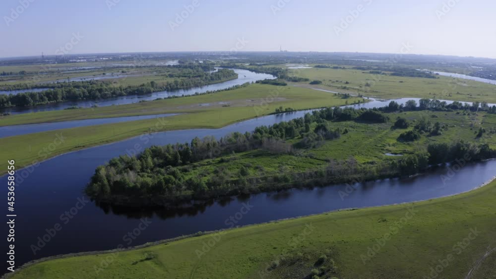 Scenic aerial view of a river and green fields in a countryside Scenic aerial view of a river and green fields in a countryside