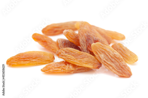 Micro close-up and details of Organic golden long size raisins (dry grapes ) isolated over white background.
