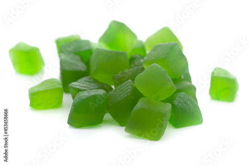 Micro close-up and details of Organic Indian green tutti frutti sweet soft candy  isolated over white background. photo