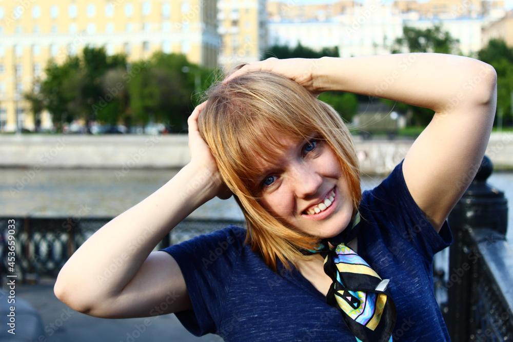 Closeup portrait of a young woman on the bridge blond beauty girl outdoors women street