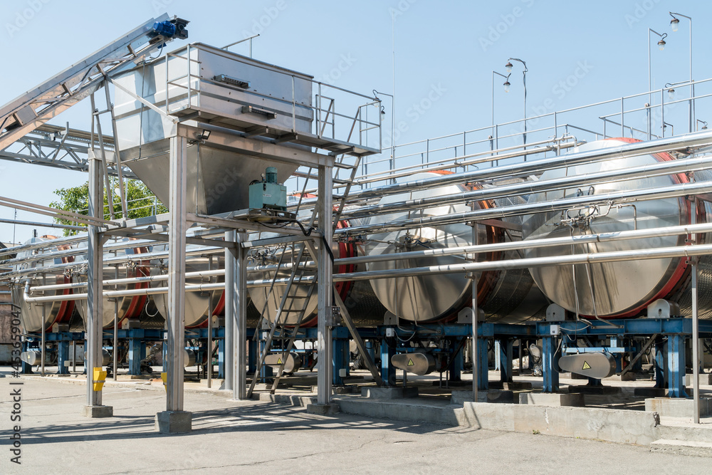 Stainless steel equipment for wine fermentation at a winery. Stainless steel equipment for wine fermentation at a winery.