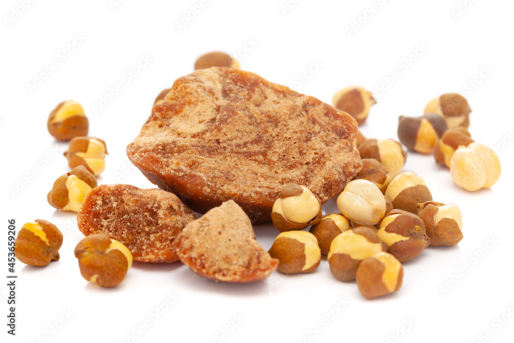 Micro close-up and details of Organic Indian roasted chana (Cicer arietinum) with gud (jaggery) isolated over white background. Micro close-up and details of Organic Indian roasted chana (Cicer arietinum) with gud (jaggery) isolated over white background.