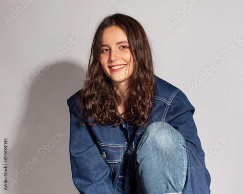 studio portrait of youn caucasian woman in jeans jacket photo