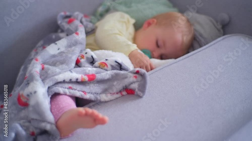 Adorable Cute Causian Toddler Girl Taking Afternoon Nap Sleeping Peacefully Under Blacket Cooling Her Foot photo