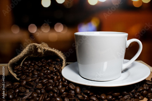 Coffee cup and saucer on a wooden table. Dark background.