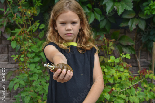 child girl found a combat grenade outside the photo without processing