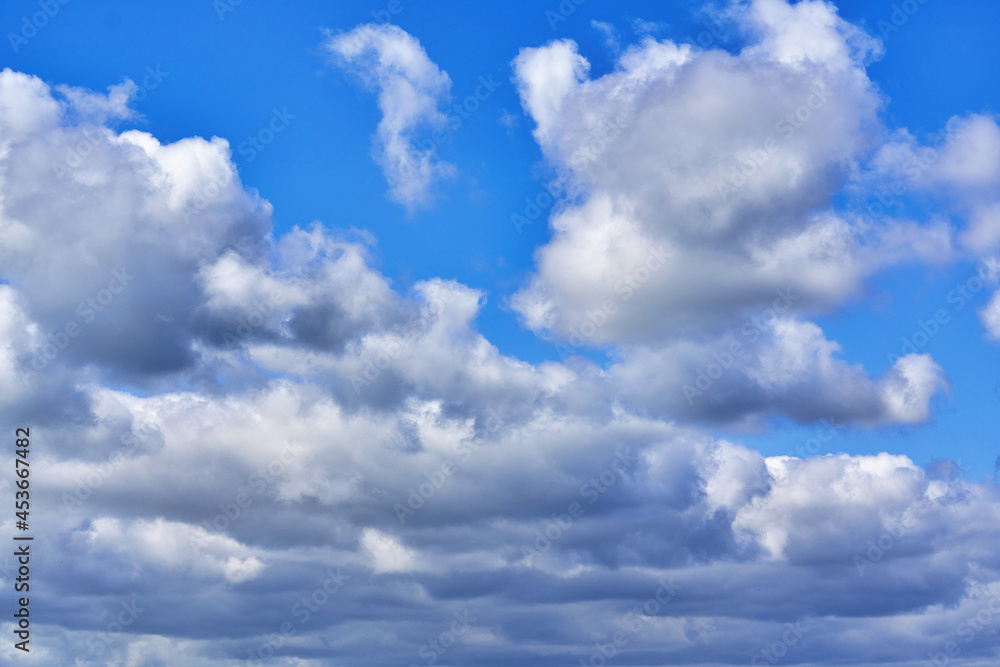 White cumulus clouds on blue sky background, natural phenomenon White cumulus clouds on blue sky background, natural phenomenon