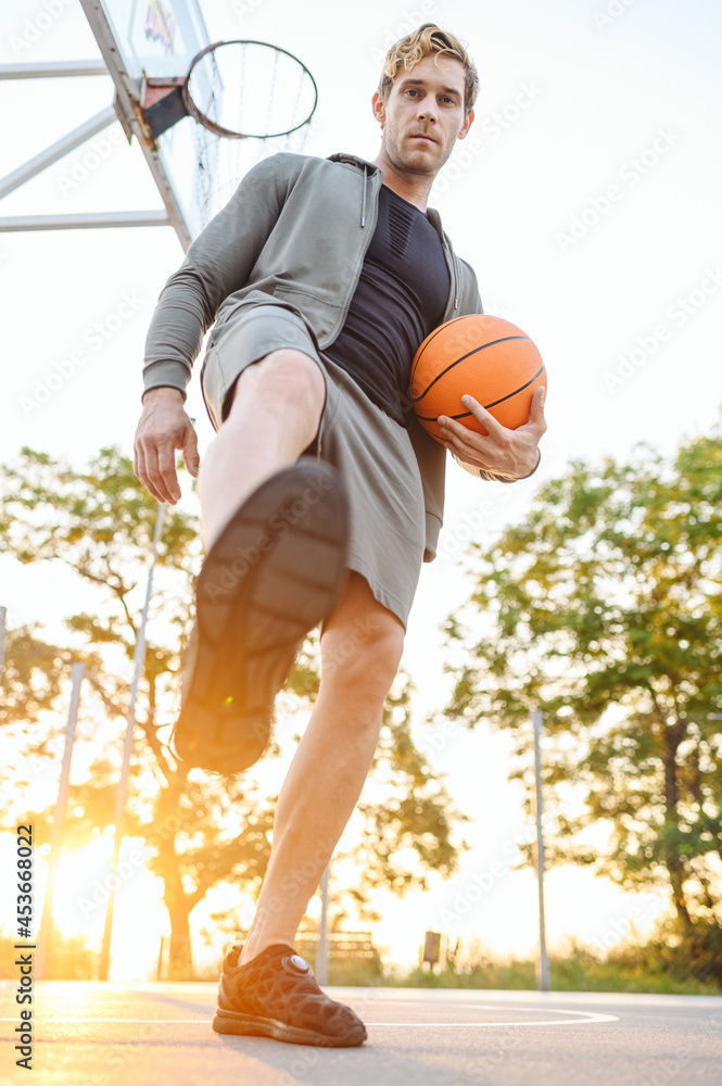 Full body bottom view young sunlit sporty sportsman man in sports ...
