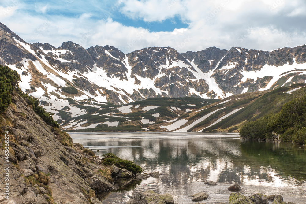 The Valley of the Five Polish Ponds in the High Tatras at the beginning of June, partially covered with remnants of snow