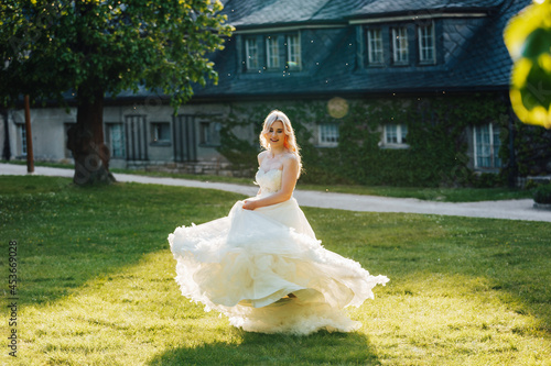 beautiful, blond bride in the park with a big, white dress at a sunny day