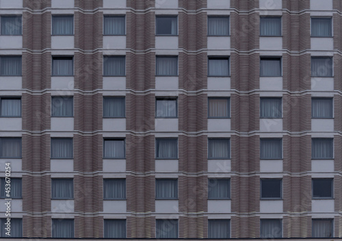 Facade of a building with windows in background. Front view.