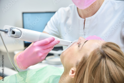 Orthodontist scanning teeth with 3d scanning machine.