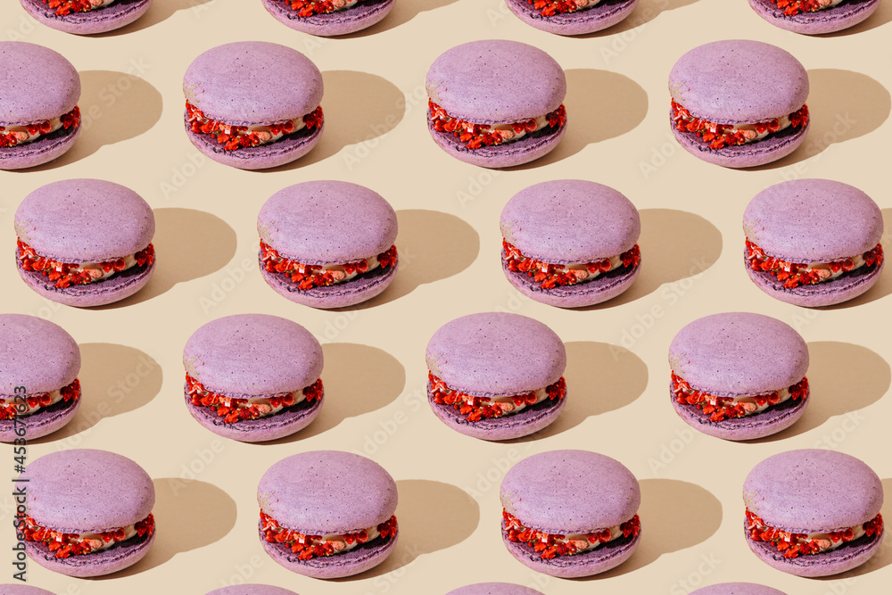 lilac Macarons pattern on beige background. Colorful french desserts. lilac Macarons pattern on beige background. Colorful french desserts.