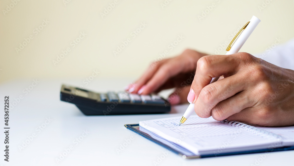 Close-up of the hands of a woman writing in a notebook Close-up of the hands of a woman writing in a notebook