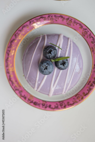 lavender cake on blue table with flowers