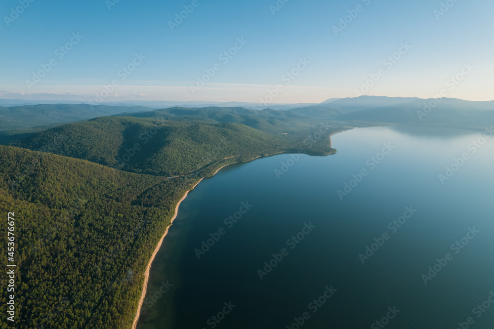 Obraz premium Summertime imagery of Lake Baikal is a rift lake located in southern Siberia, Russia Baikal lake summer landscape view from a cliff near Grandma's Bay. Drone's Eye View.