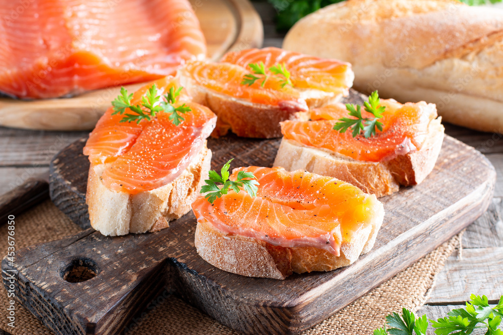 Open sandwich, toast with salmon, butter on table. Morning healthy breakfast with fish Open sandwich, toast with salmon, butter on table. Morning healthy breakfast with fish