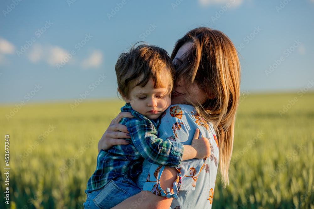 little boy hugs mom in a wheat field little boy hugs mom in a wheat field