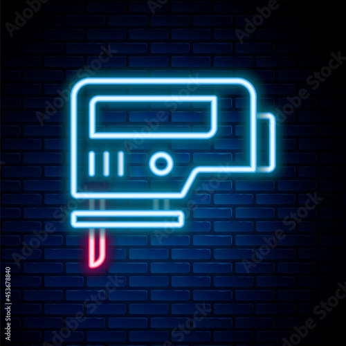 Glowing neon line Electric jigsaw with steel sharp blade icon isolated on brick wall background. Power tool for woodwork. Colorful outline concept. Vector