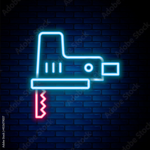 Glowing neon line Electric jigsaw with steel sharp blade icon isolated on brick wall background. Power tool for woodwork. Colorful outline concept. Vector
