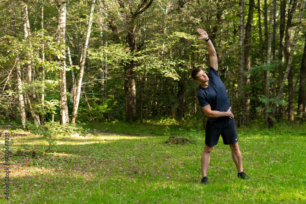 A man athlete runs in the park outdoors, around the forest, oak trees green grass young enduring athletic athlete run nature, workout jogger training recreation jog, park outside. Autumn leisure A man athlete runs in the park outdoors, around the forest, oak trees green grass young enduring athletic athlete run nature, workout jogger training recreation jog, park outside. Autumn leisure
