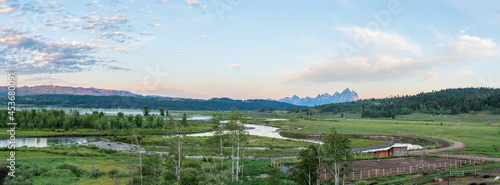 Panorama of Buffalo Fork River Valley in Morning Light with Mist on the River and the Grand Teton Mountains in the Background photo