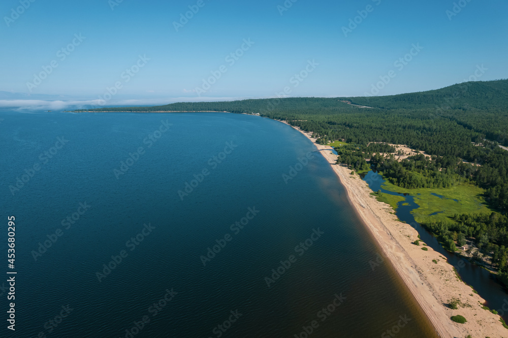 Fototapeta premium Summertime imagery of Lake Baikal is a rift lake located in southern Siberia, Russia. Baikal lake summer landscape view. Drone's Eye View.