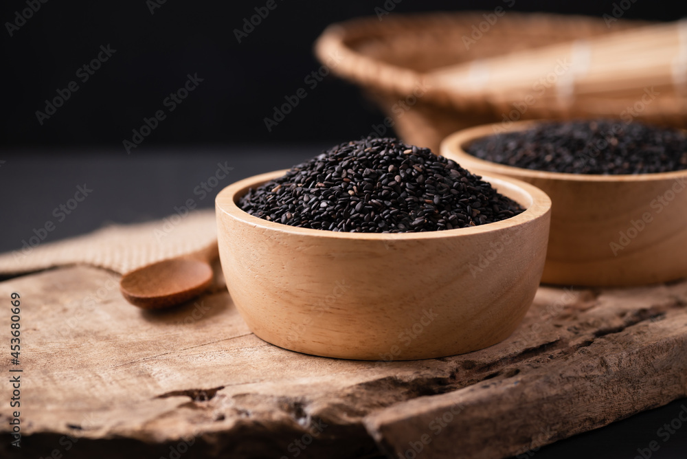 Black sesame seeds in a bowl with spoon on wooden, Still Life Black sesame seeds in a bowl with spoon on wooden, Still Life