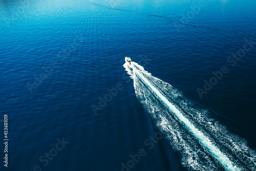 Aerial view of motor boat sailing in the sea. Amazing seascape with the fishing boat. 